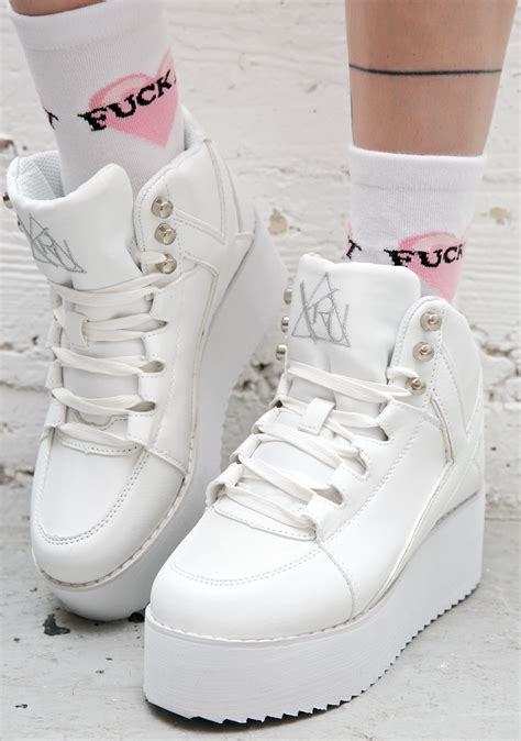 high top white platform sneakers.